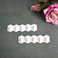 Set of 10 white plastic adhesive wall hooks for drill-free hanging.