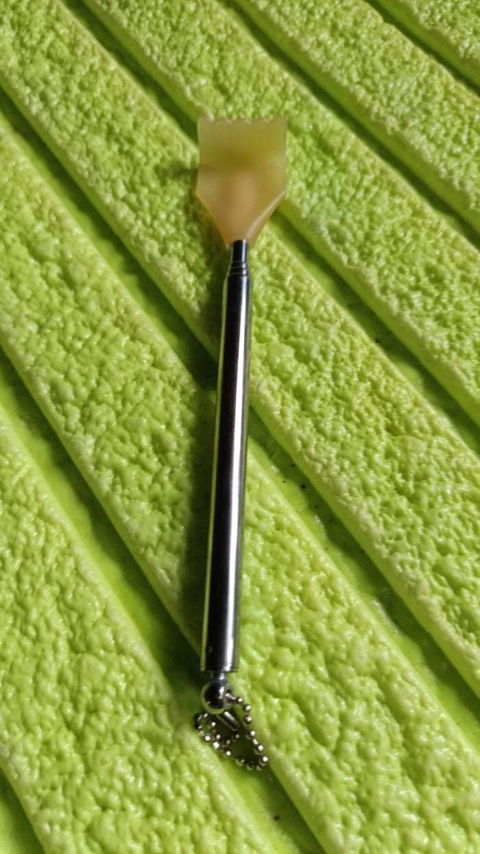 The compact back scratcher displayed neatly in its product packaging.