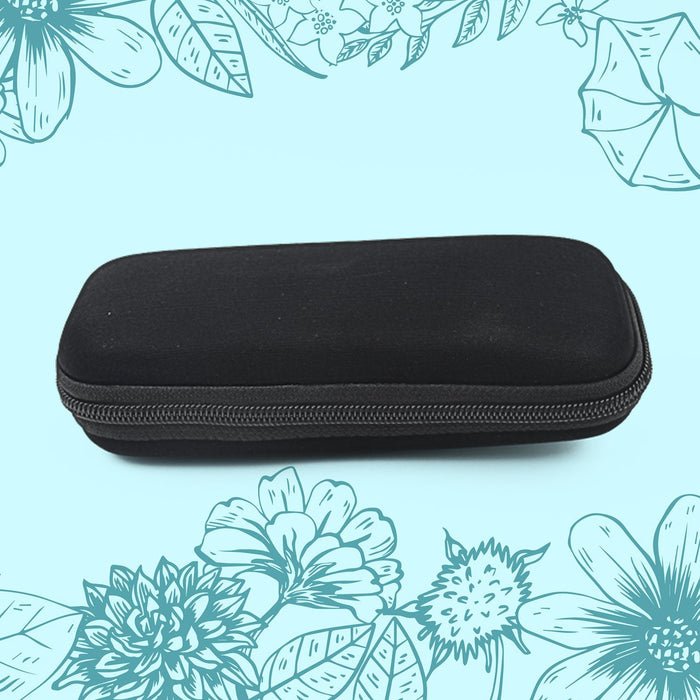 A black, rectangular zippered case with rounded corners is centered against a light blue background with floral outlines.