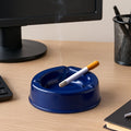 Dark blue plastic ashtray with wide bowl and 3 cigarette slots