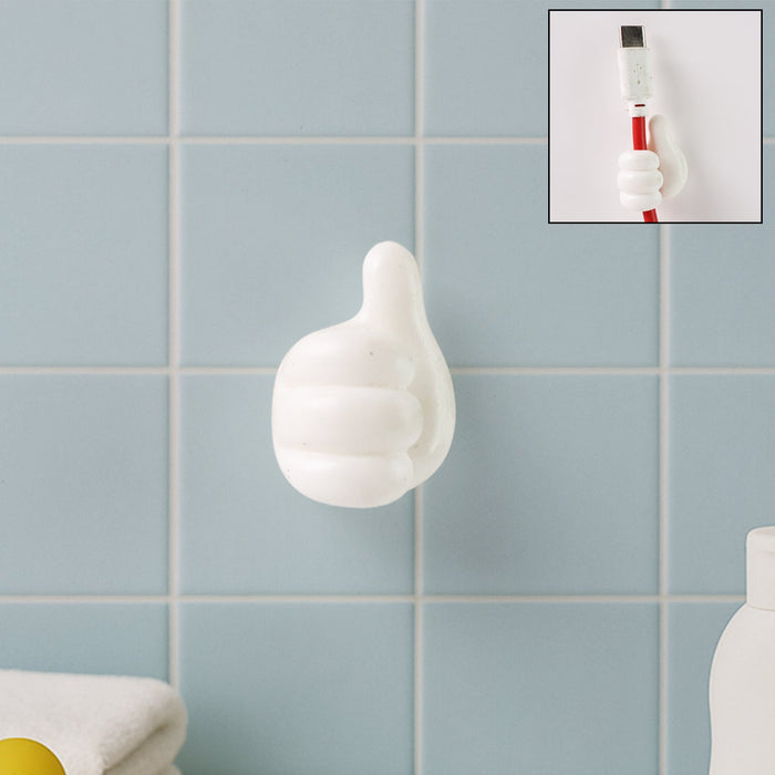 White hand-shaped wall clip holding keys and cables with thumb grip