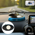 Helicopter car air freshener diffuser with rotating blades on dashboard