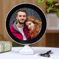 LED Magic Mirror Photo Frame glowing with a picture inside, on a white table.