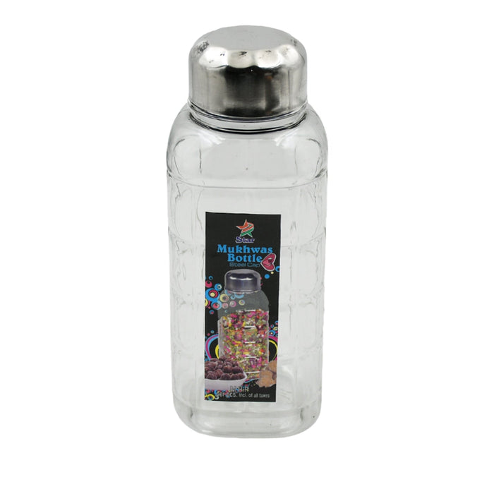 Transparent mukhwas bottle sitting on a kitchen counter with snacks