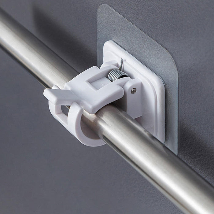 Close-up of wall-mounted adhesive towel rod holder with hanging towels