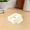 Plastic mobile phone stand mounted on wall with mobile and remote