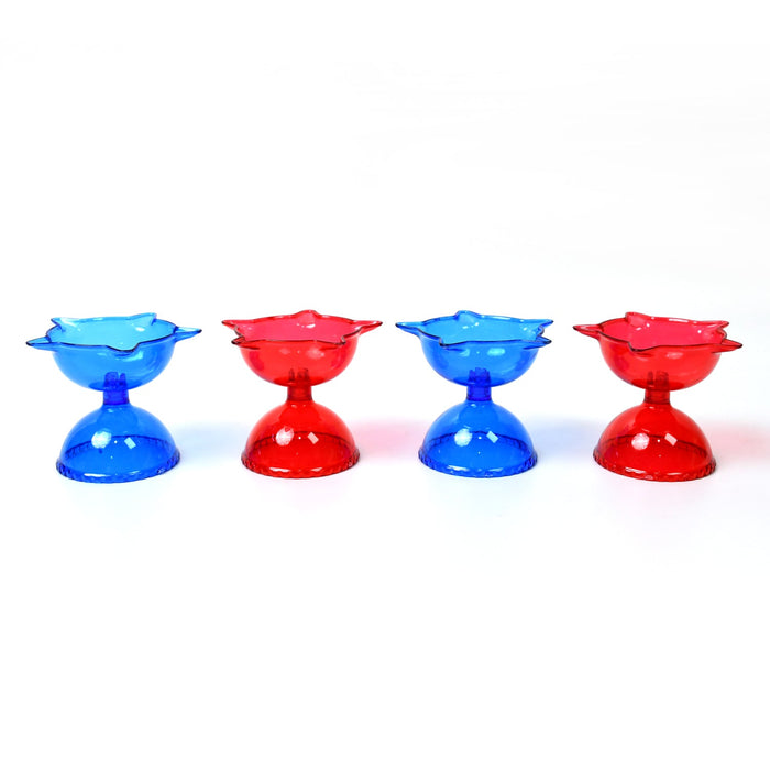 The colourful plastic Reflection Diya Set creating a warm glow in a festive setting.