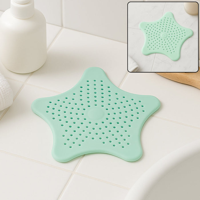 Mint green silicone star shaped sink strainer placed on bathroom sink drain