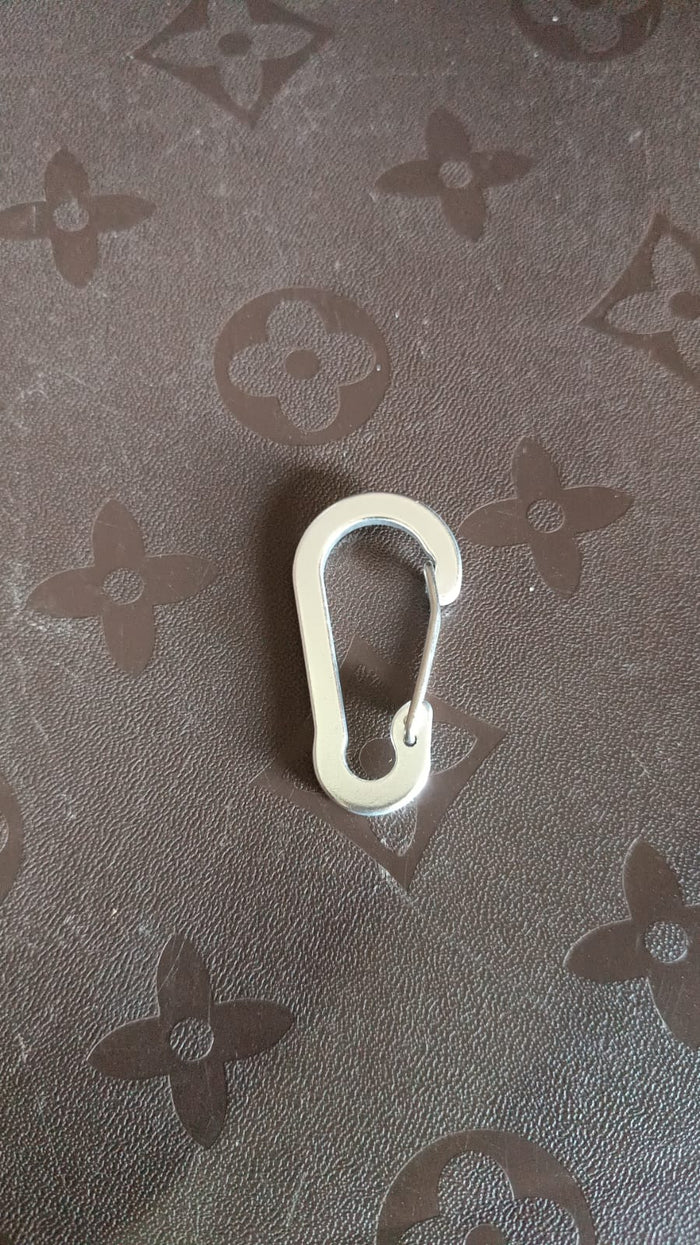 Close-up view of small snap hook clasp showing spring clip