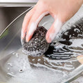 Close-up of a robust stainless steel scrubber, ideal for tough kitchen cleaning.
