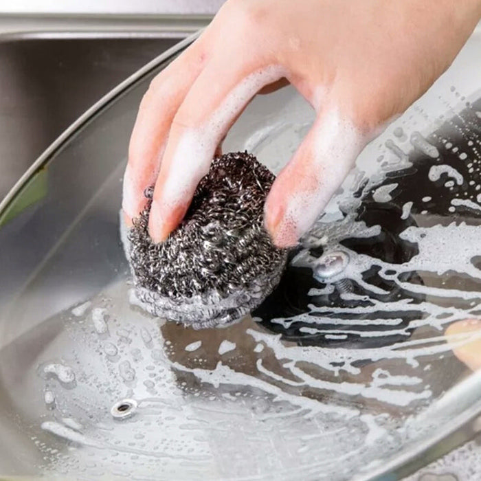 Close-up of a robust stainless steel scrubber, ideal for tough kitchen cleaning.