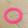 A bulk pack of 100 multi-colored telephone wire hair bands.