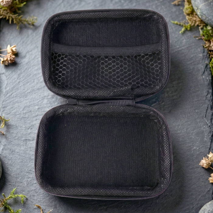 Open empty travel storage case showing interior compartments