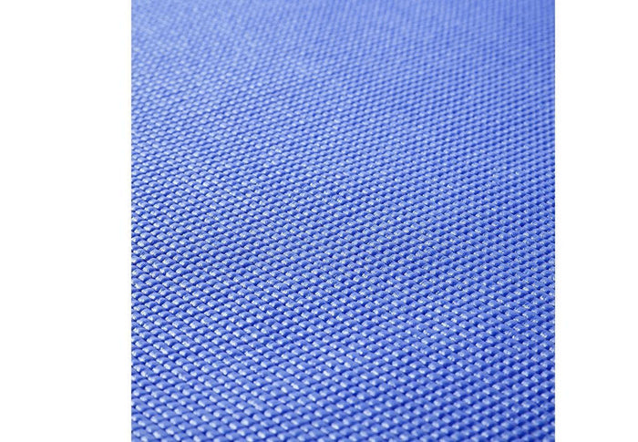Eco-friendly Yoga Mat unrolled on a wooden floor.
